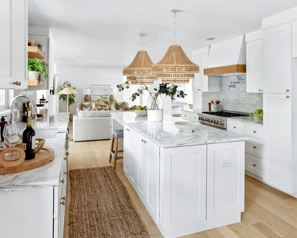 Coastal themed kitchen featuring natural style pendant lights above the kitchen island.