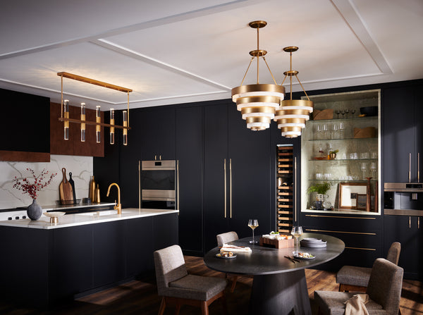 Multi-light pendant showcased above a modern kitchen island and two medium-sized pendants above a dining table.