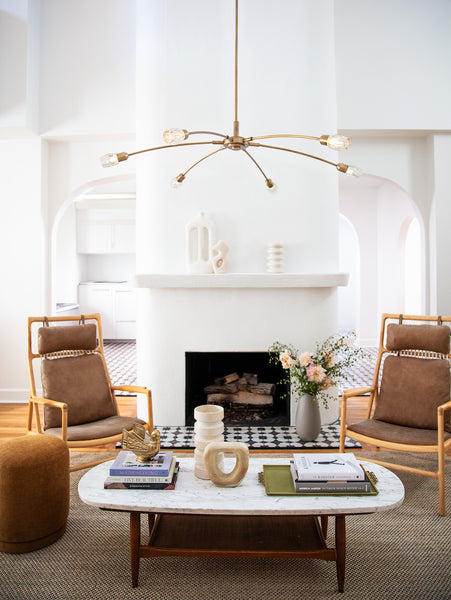 A mid-century modern-inspired chandelier showcased as a statement piece in a contemporary living room setting.
