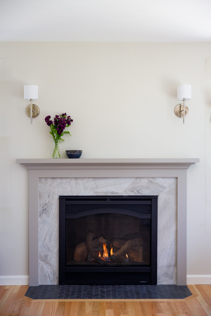 Fireplace with mantle and flowers