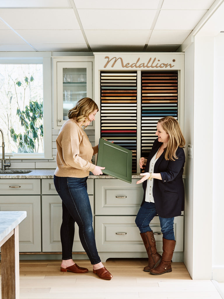 Kristina Crestin and Leah Bonarrigo picking samples from Medallion Cabinetry