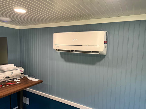 Wall unit inside of a smaller office area with blue wallpaper