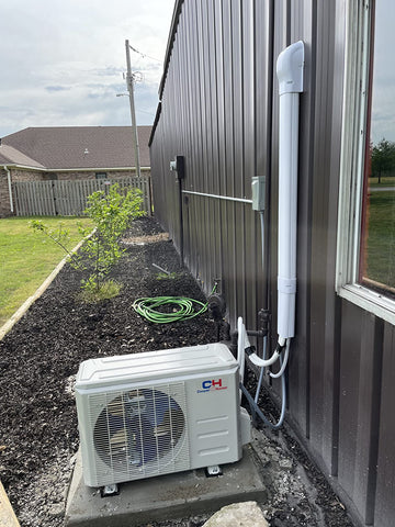 Condenser unit sitting on a concrete platform hooked in an aesthetically pleasing fashion connected to a mobile home