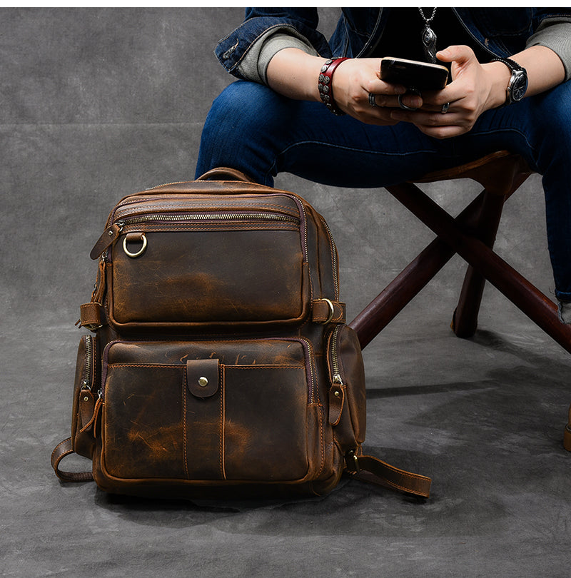 sleek Brown real Leather carry on Backpack with adjustable strap and quilted laptop sleeve to store a macbook and an ipad tablet