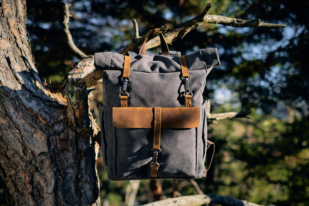 vintage hiking canvas backpack hanging down a tree ideal to store footwear, underwear, workwear or streetwear