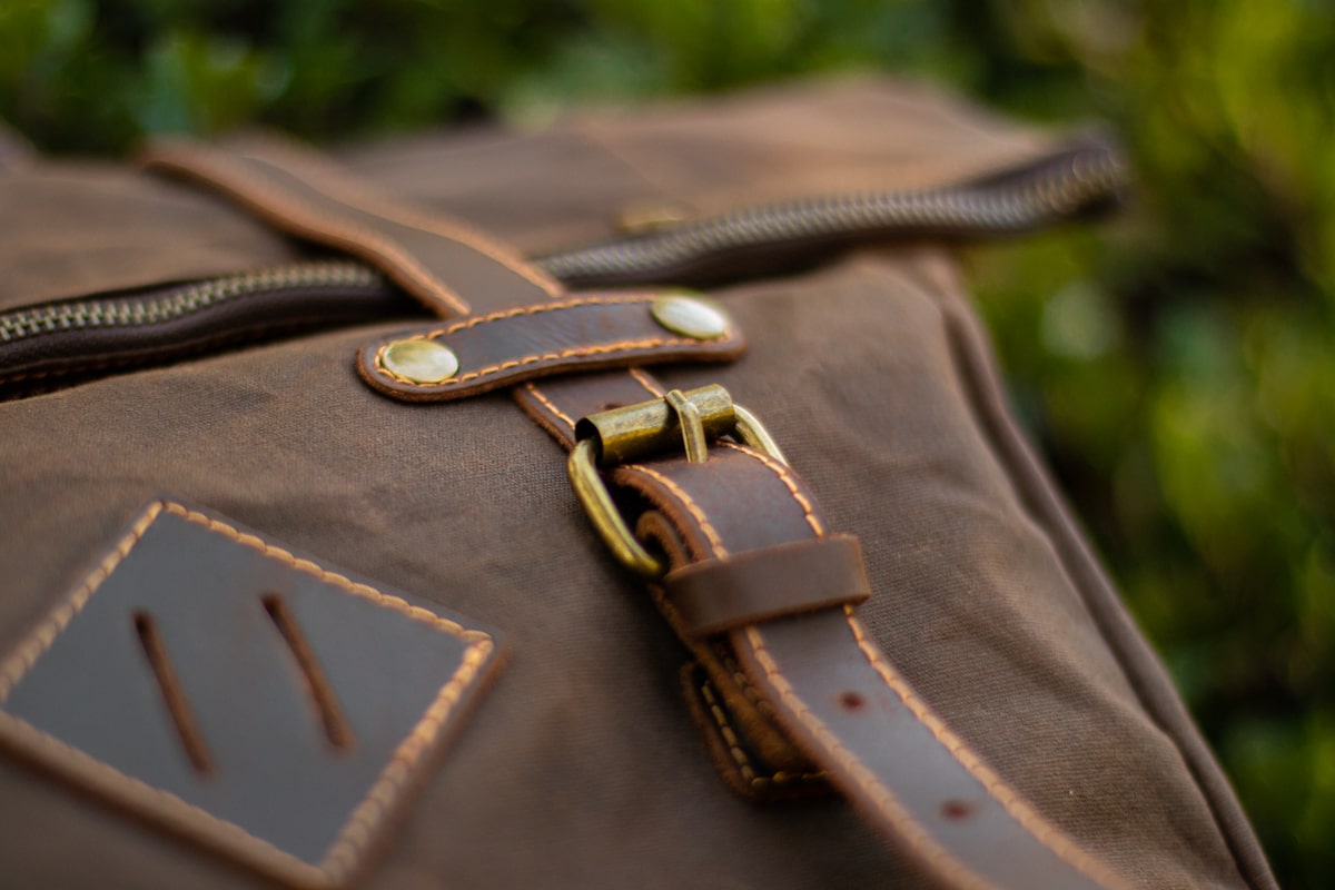 quilted backpack with metallic brass hardware and laptop sleeve with velcro strap