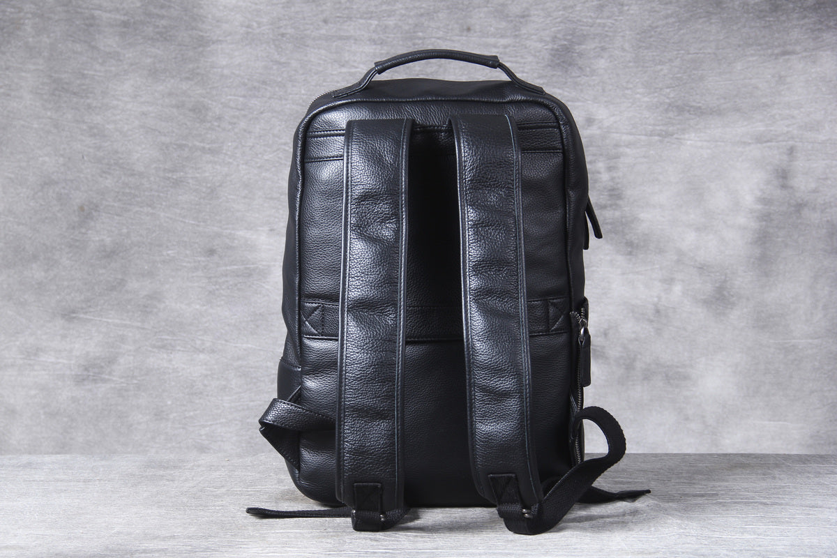 black leather backpack with laptop sleeve