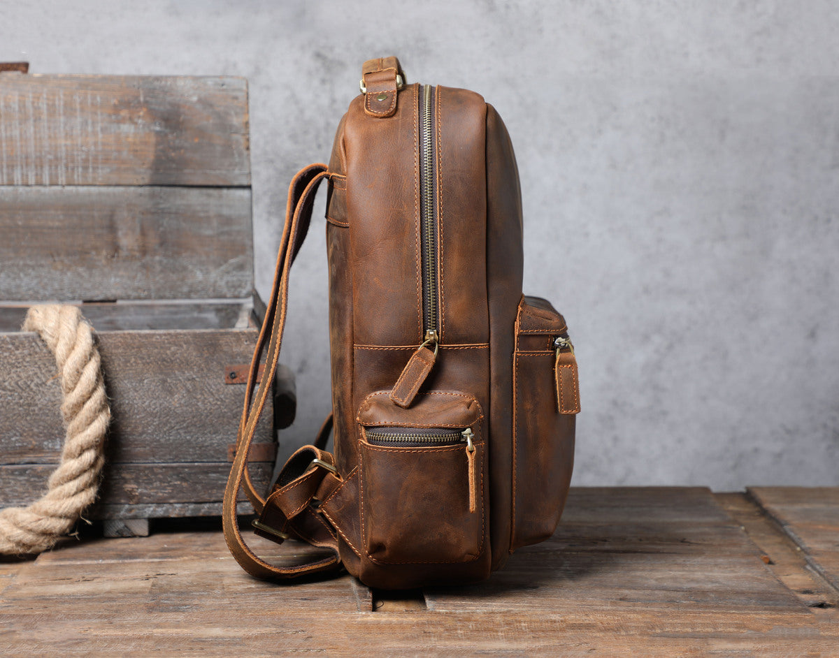 well made brown classic leather backpack for women with sturdy stitching and webbing and zipper pockets