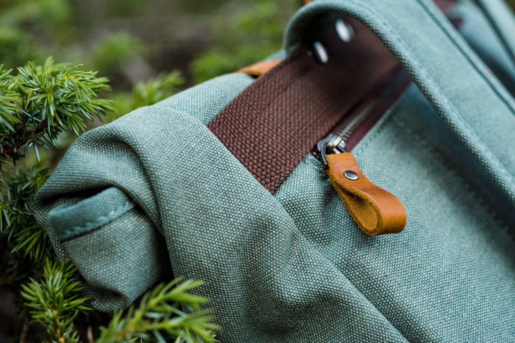 packable canvas and leather school backpack with zipped pockets to store your belongings