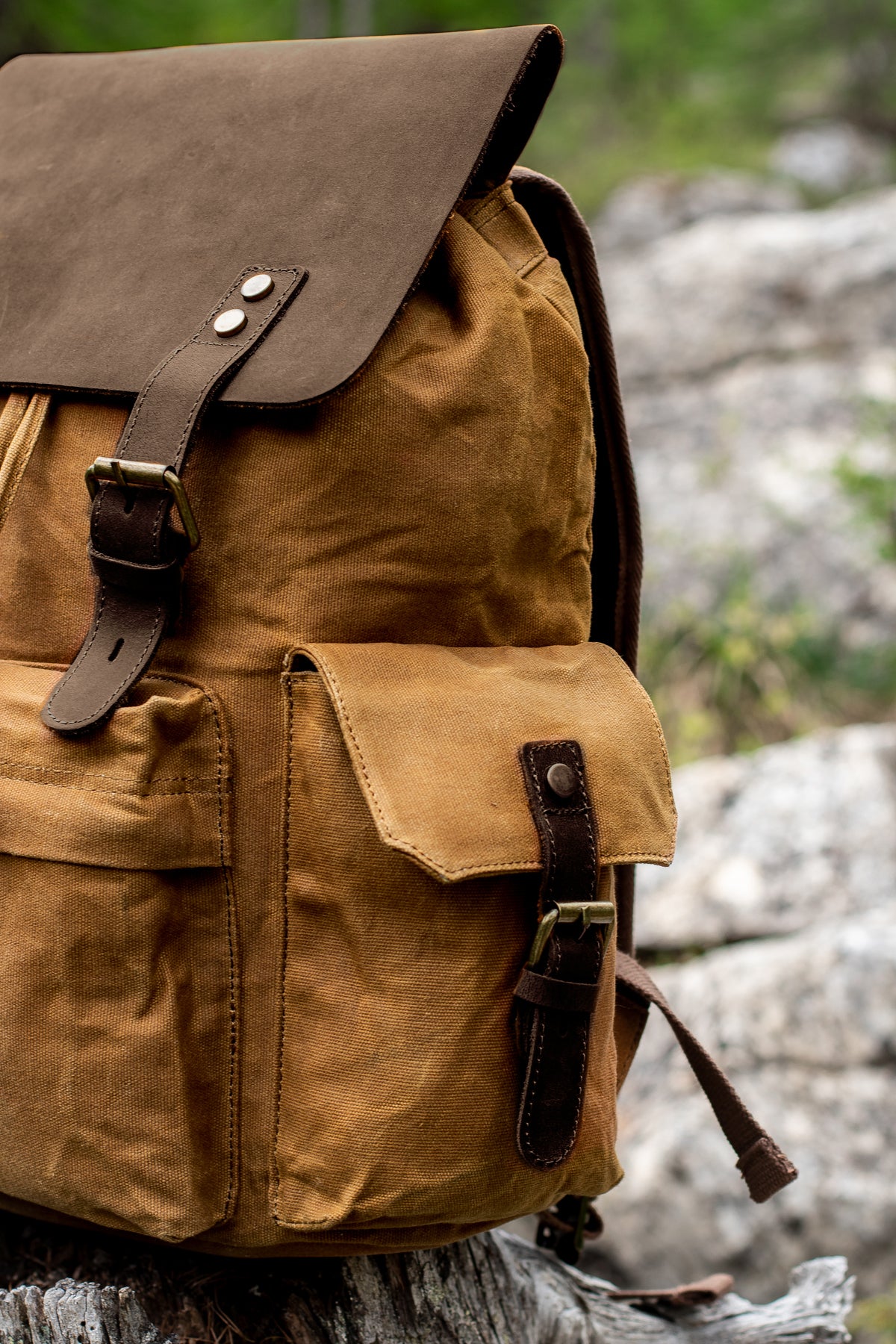 spacious front zipper pocket and brass hardware of the waxed canvas and full grain leather rucksack pack from eiken