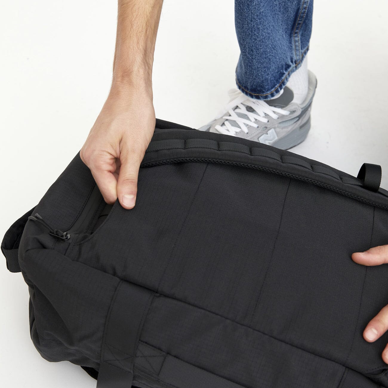 Close-up of recycled fabric detachable shoulder straps on the Wanderer backpack