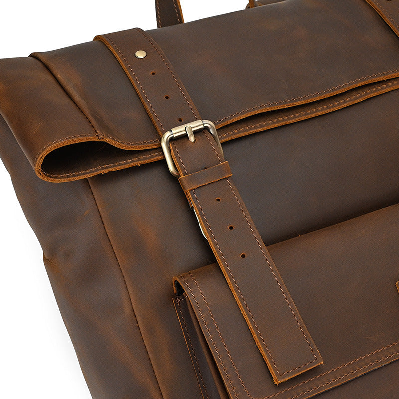 fold top leather book-bag with sturdy stitching and webbing