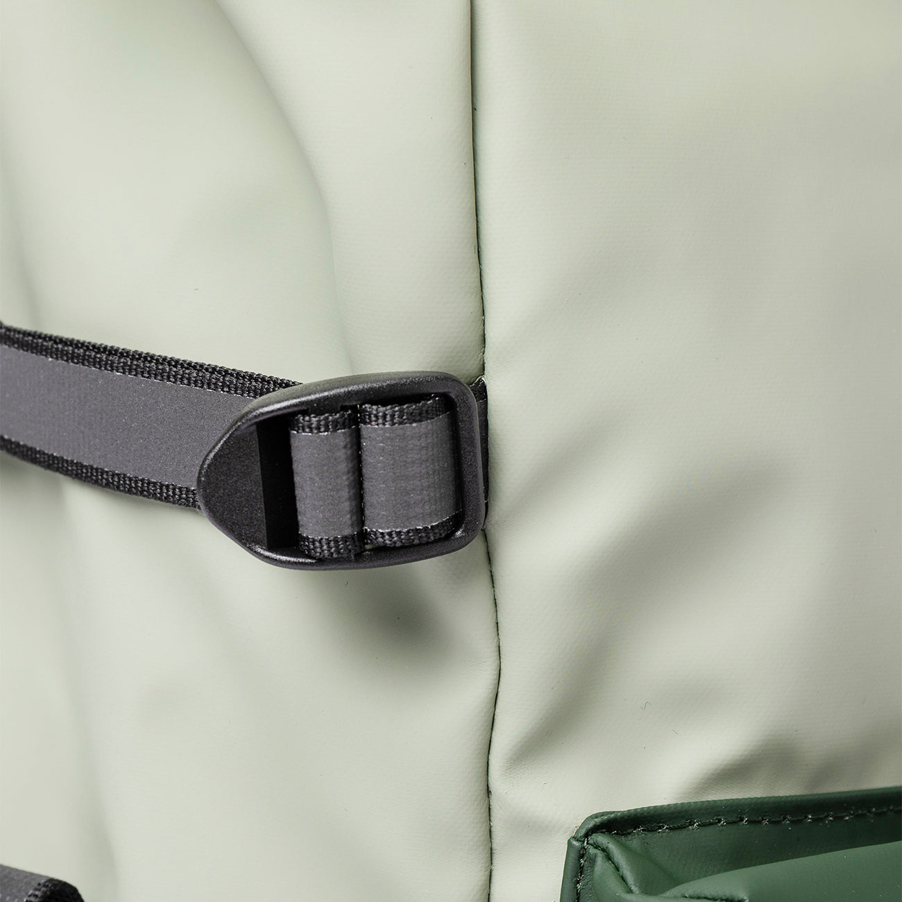 green model side compression straps on one of the best commuter backpacks