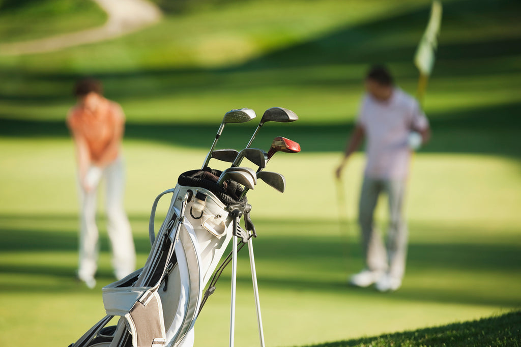 Italy, Kastelruth, Golfers playing golf on golf course