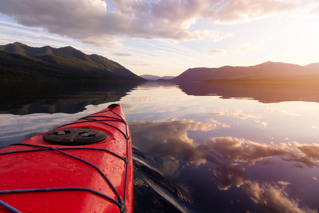 Kayaking in Lake McDonald during a sunny summer sunset