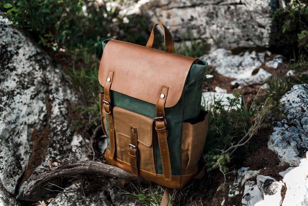 goteborg laptop canvas backpack with a leather flap, side pockets for a water-bottle or umbrella and a laptop sleeve