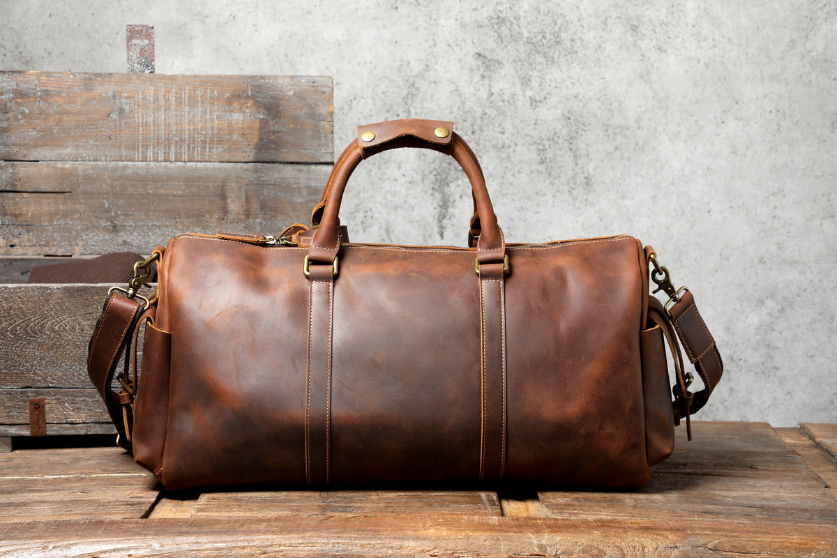 back view of a coffee leather travel duffle bag