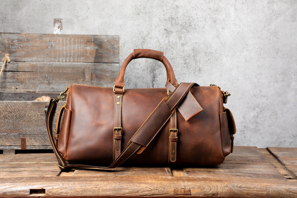 front view of a coffee leather travel duffle bag