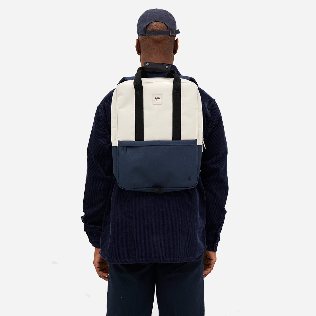 Back view of man wearing an environmentally friendly blue and white daypack
