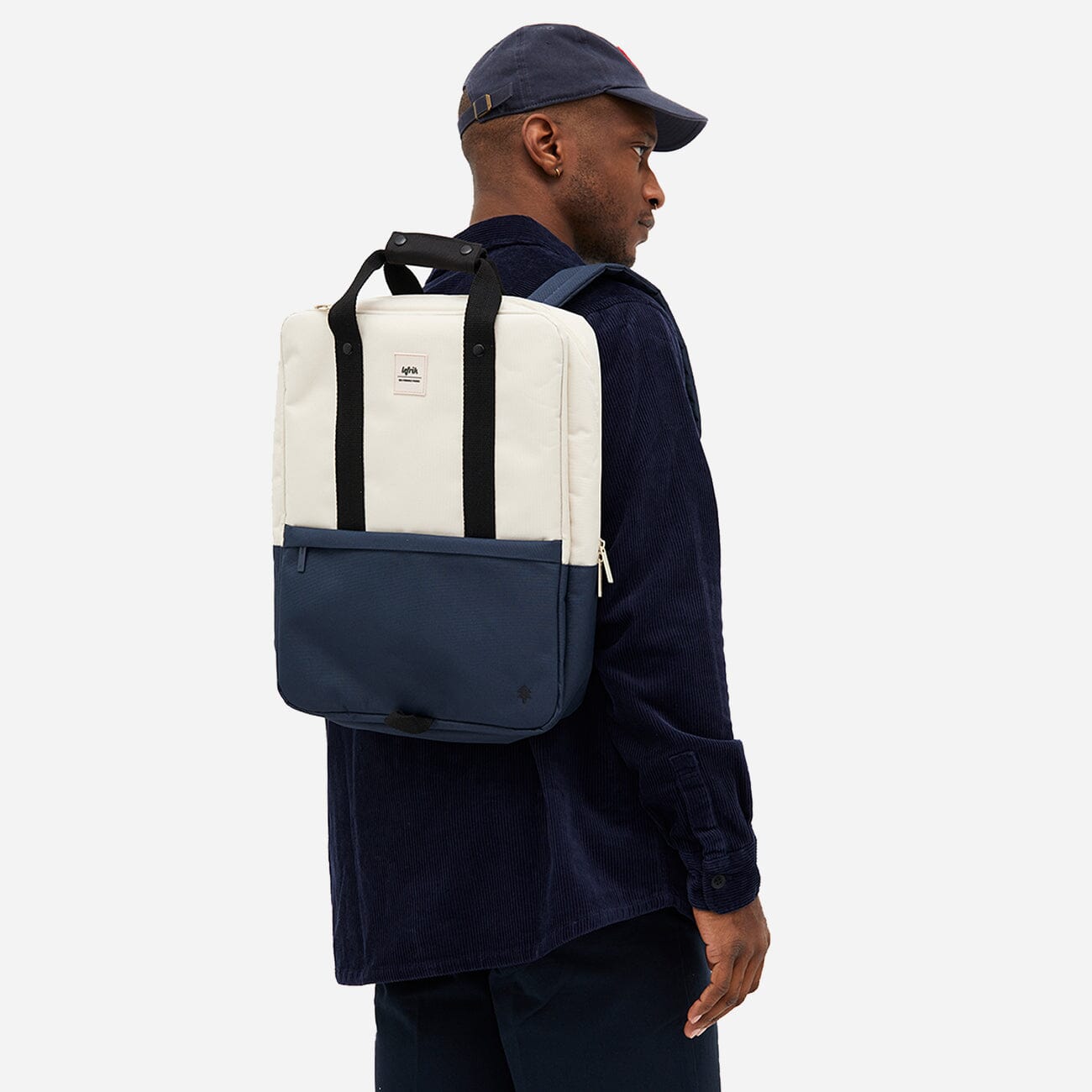 Man from the back carrying a stylish and sustainable daypack in blue and white