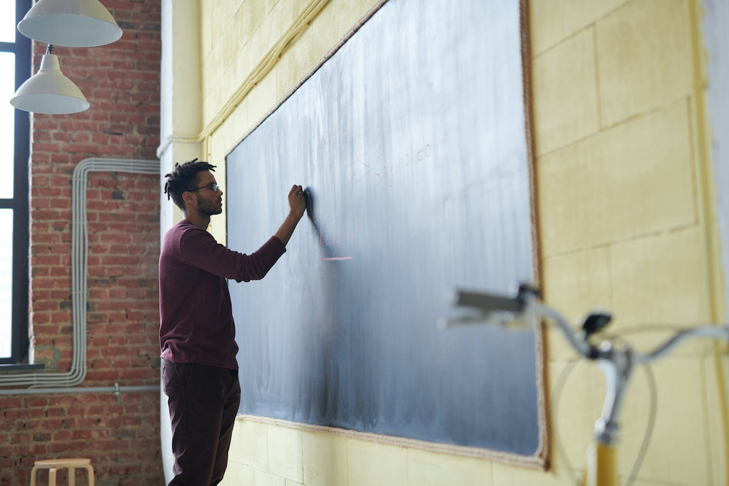 teacher in front of a black board