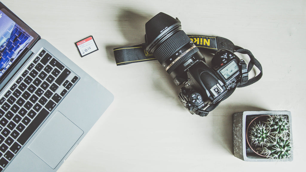 laptop, sd card and a dslr camera