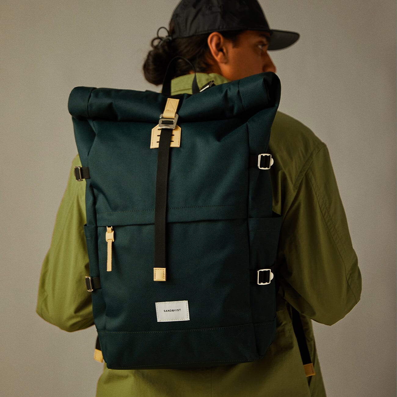 man wearing a backpack made from eco-friendly rPet brent sandqvist green color