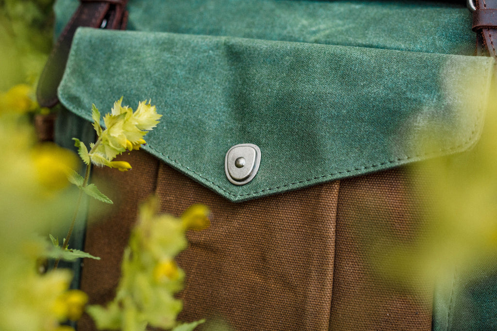 handmade roll top backpack made of water repellent waxed canvas and tanned brown leather