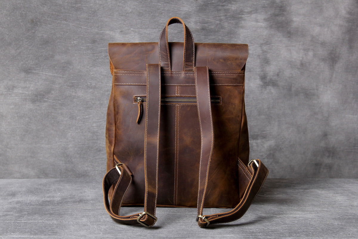 rustic and well made cognac genuine leather laptop backpack with zipper pockets and metallic buckle for everyday use