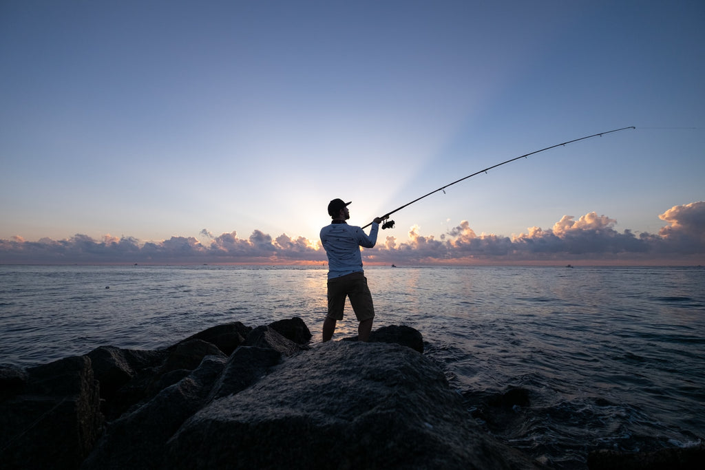 a man fishing in a lake a dawn