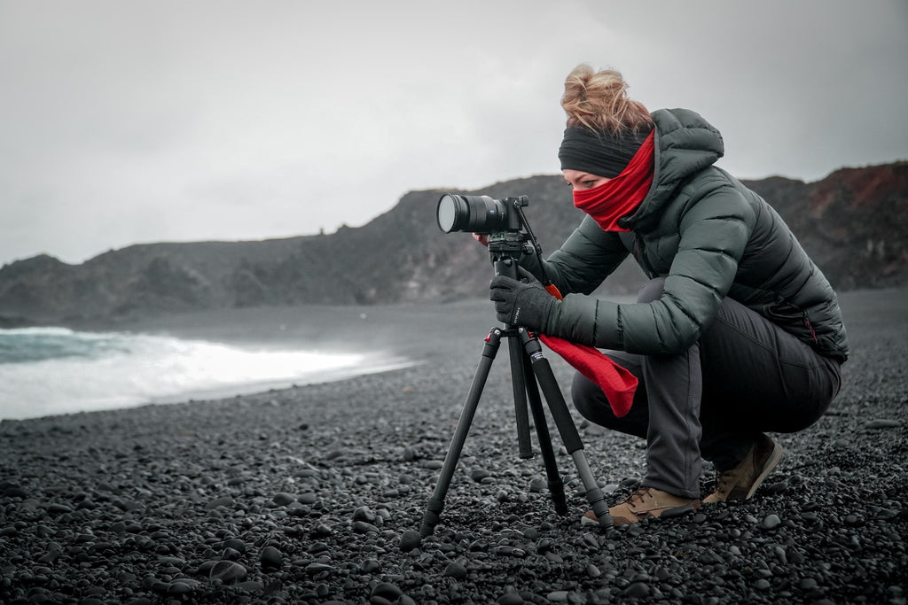 women taking a landscape photography with a dslr on a tripod