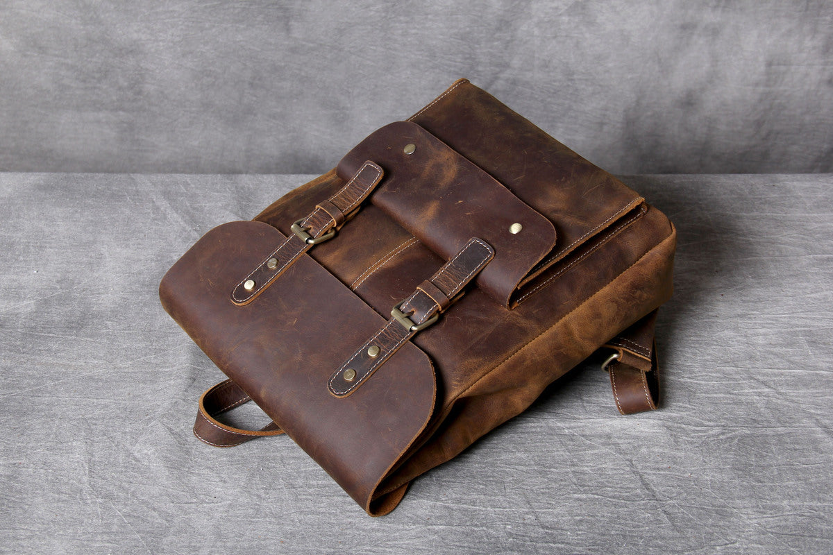 vintage carry-all tanned leather knapsack with a quilted laptop sleeve to stoore a macbook and an ipad tablet