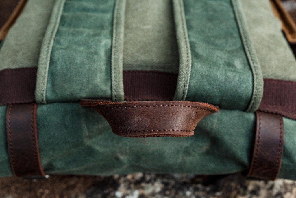 waxed canvas roll top bag with padded shoulder straps