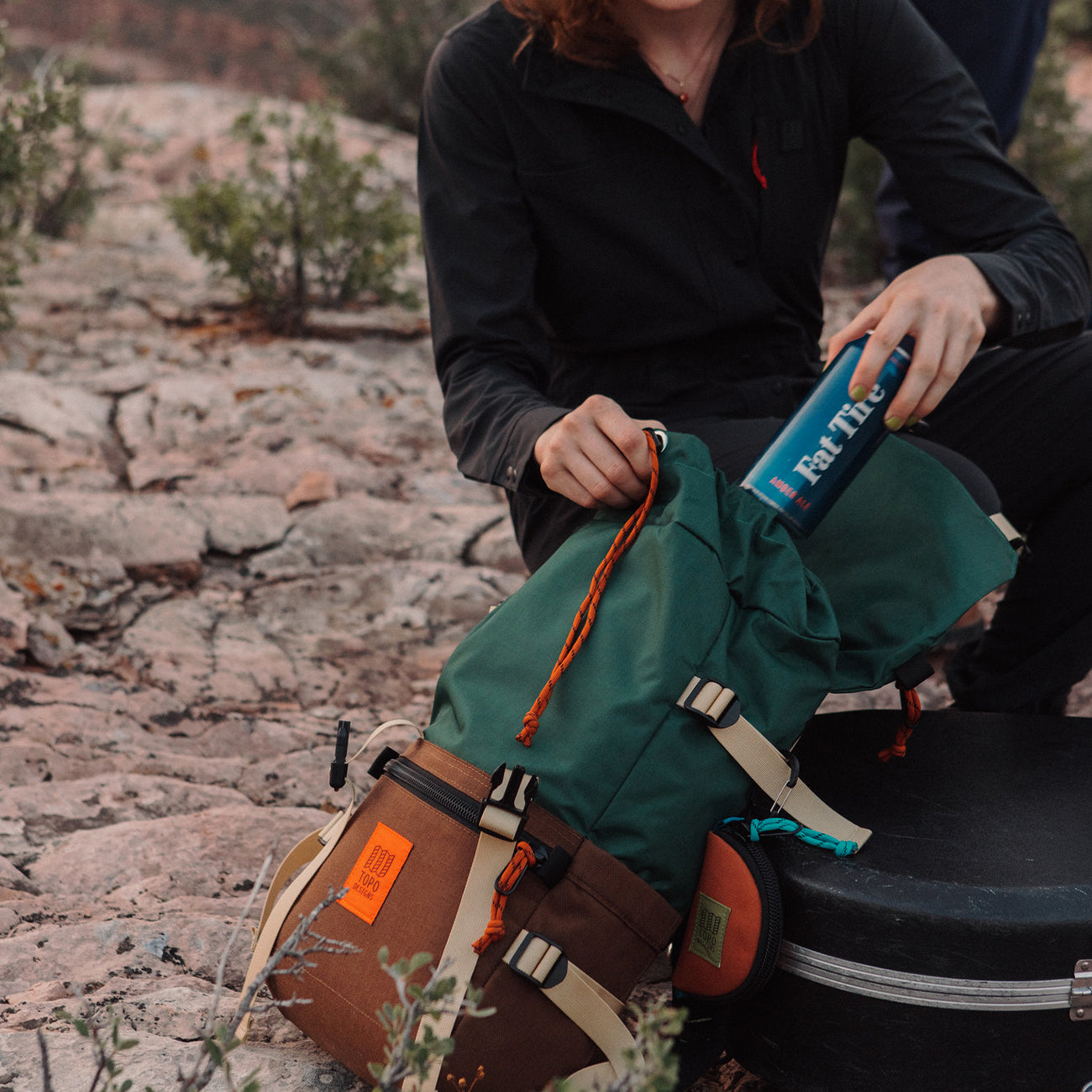 woman looking inside main compartment rover classic pack