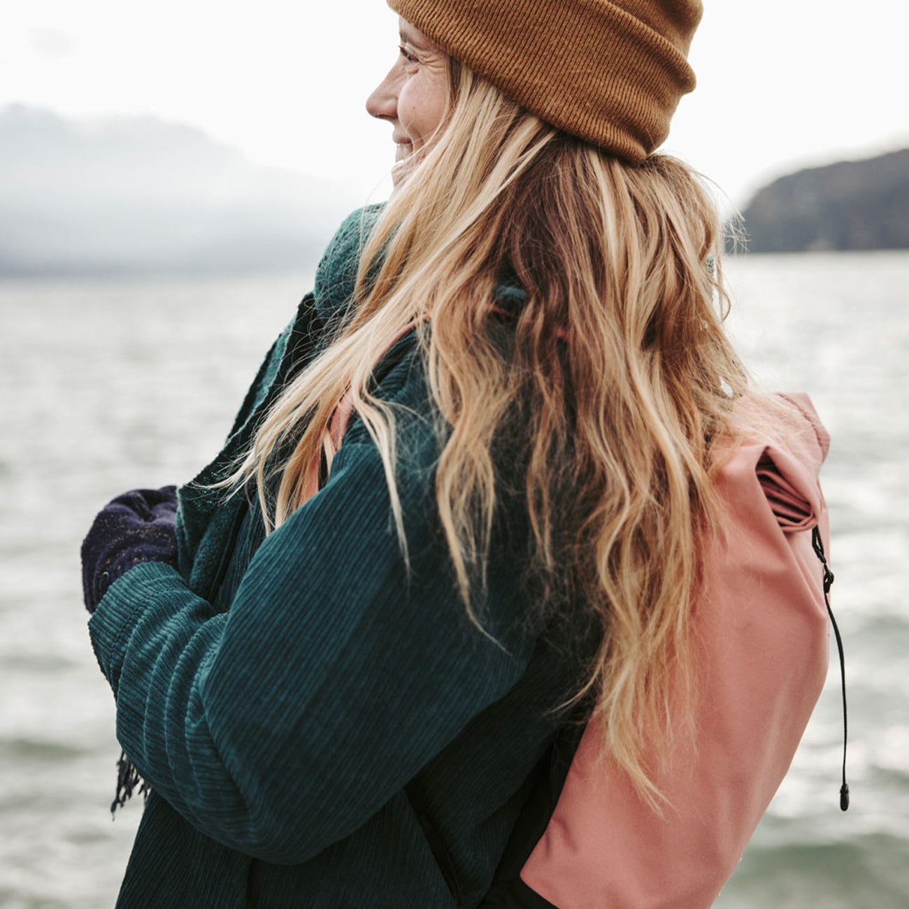 woman wearing a pink eco friendly backpack from mero mero