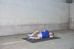 A soccer player performs hip external rotation and is at the end of the exercise