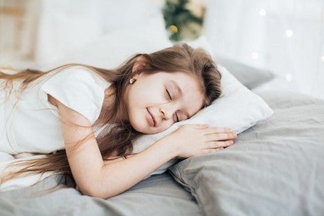 A little girl sleeping tight portraying the benefits of using a SlumberPod.