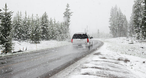  a person driving a car in the snowy weather