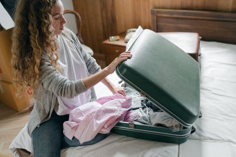 one of the best winter travel tips for families is to pack a small number of things, like the woman in the photo