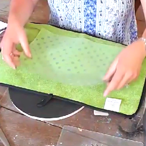 Lessen the strength of the adhesive by sticking the stencil in a towel
