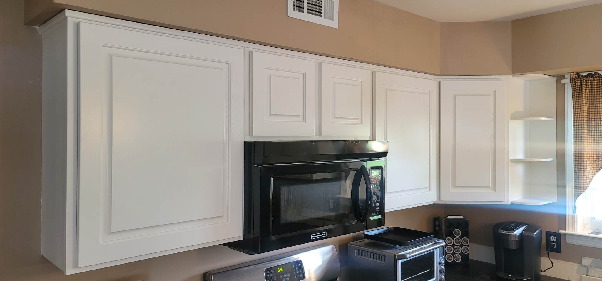 Elevating Your Home with Grace on Broadway Cabinet and Furniture Refinishing Featuring a Kitchen Refinished in White Wood Coating After Refinishing