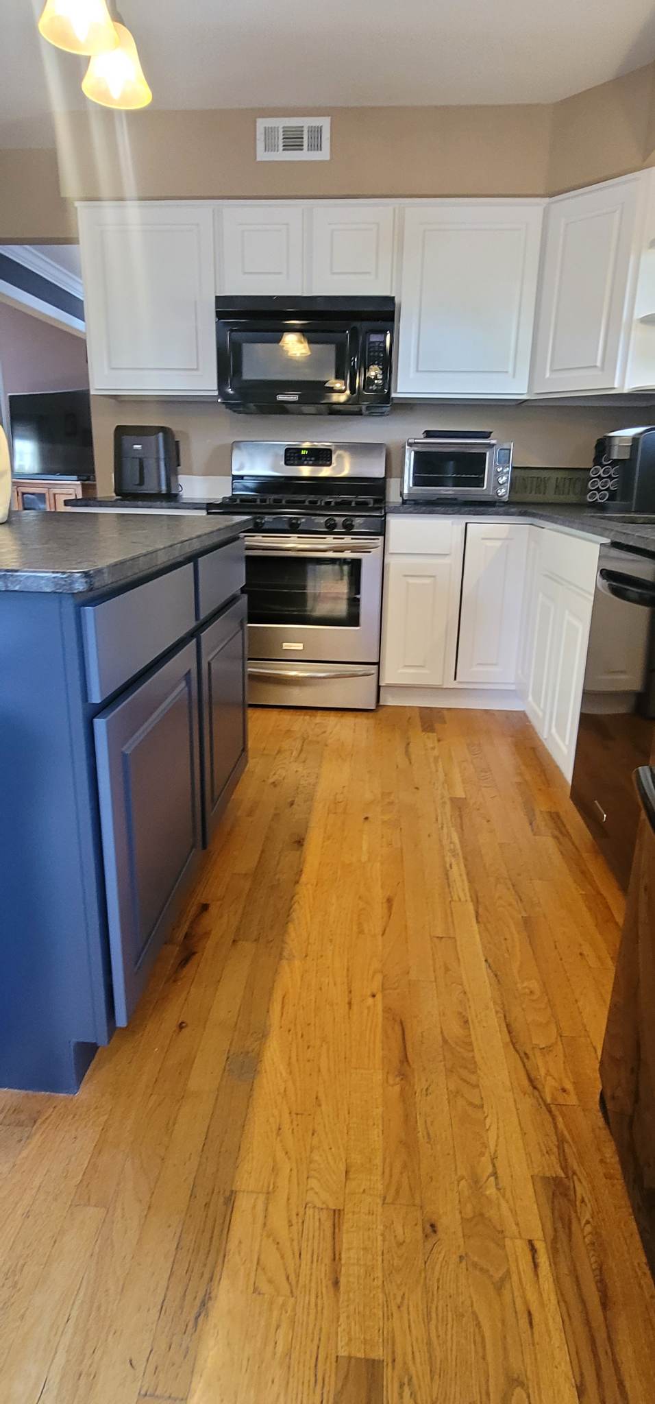 Elevating Your Home with Grace on Broadway Cabinet and Furniture Refinishing Featuring a Kitchen Refinished in White Wood Coating After Refinishing