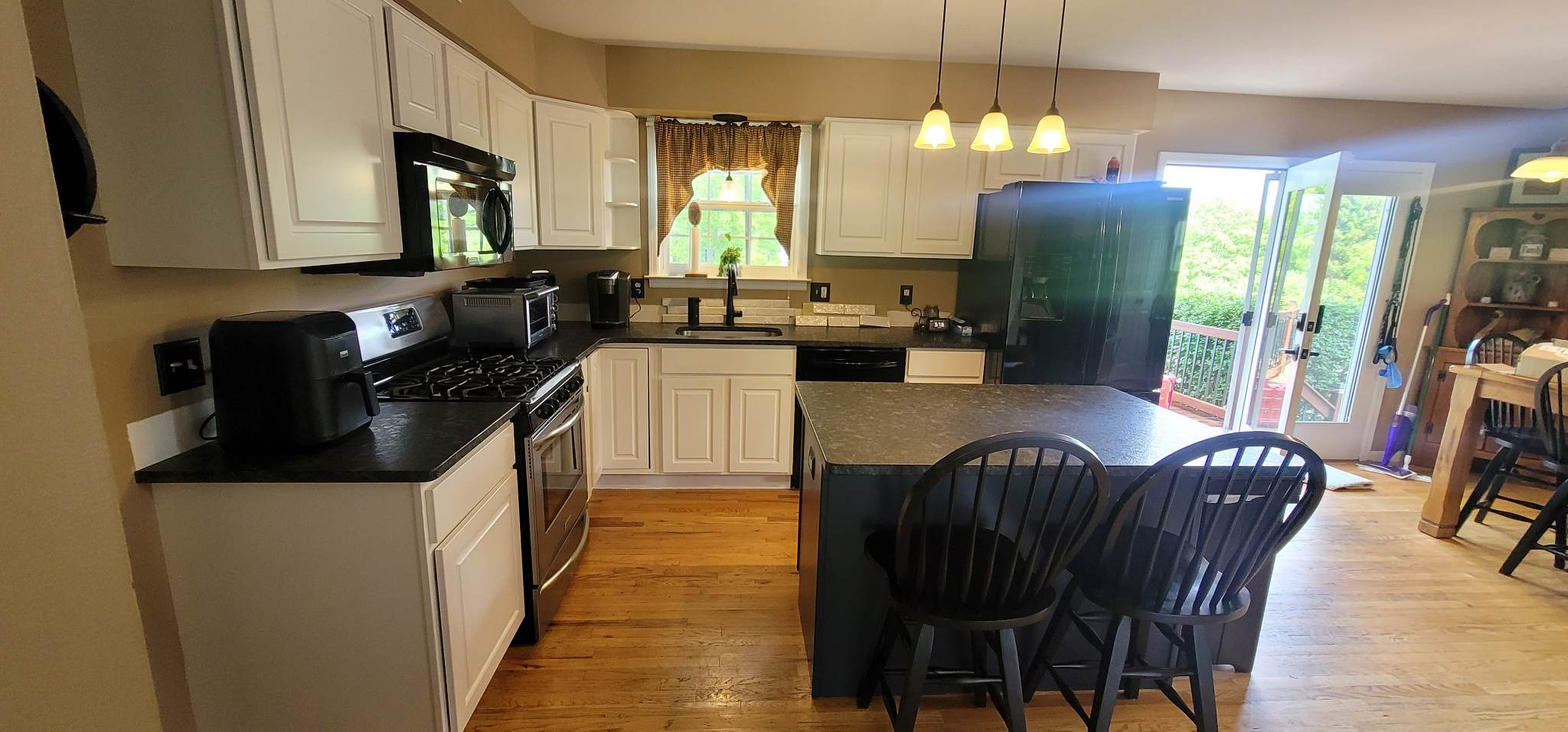 Elevating Your Home with Grace on Broadway Cabinet and Furniture Refinishing Featuring a Kitchen Refinished in White Wood Coating After Refinishing