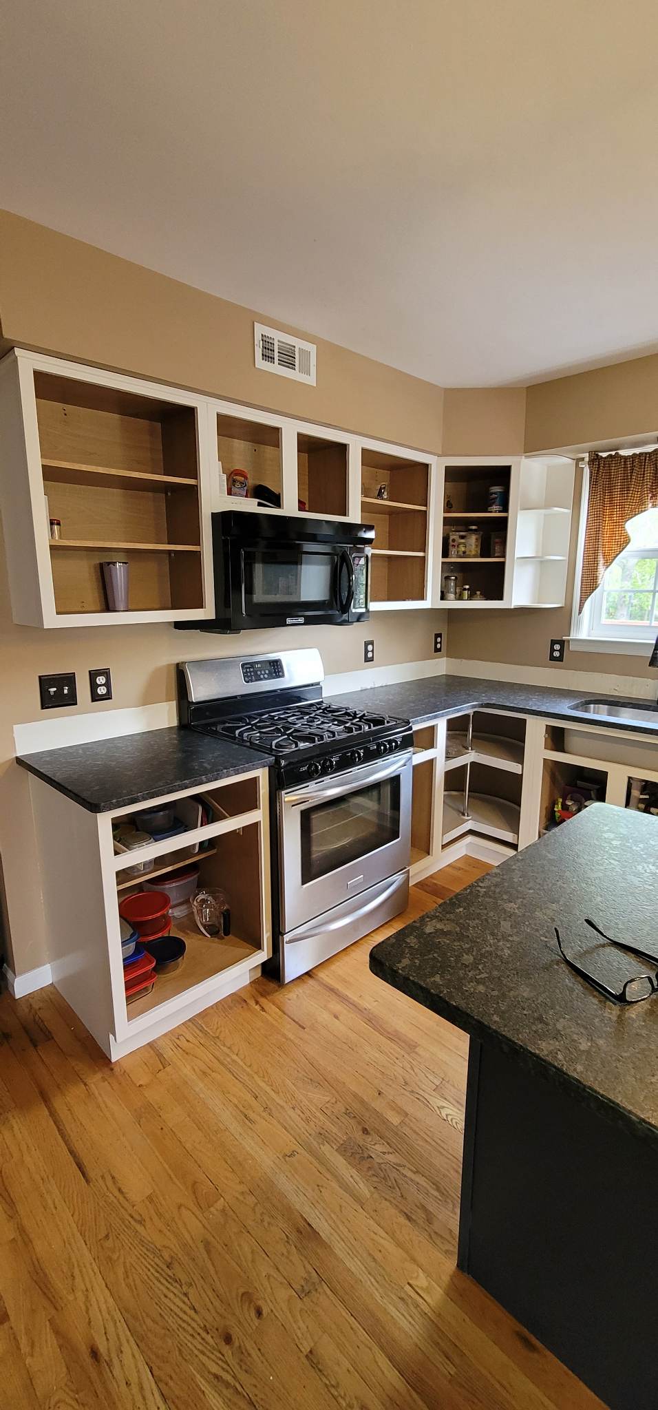 Elevating Your Home with Grace on Broadway Cabinet and Furniture Refinishing Featuring a Kitchen Refinished in White Wood Coating During Refinishing