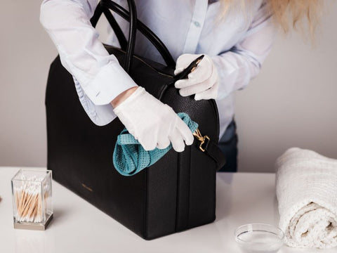 polishing hardware on a purse