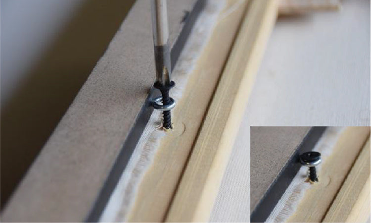 Use black screws through eye screws to pull canvas up tight to frame