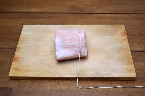 Cooking thread tied on Ends of Pork Roll