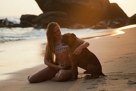 woman and her dog on the beach