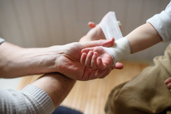 woman bandaging a bleeding wound