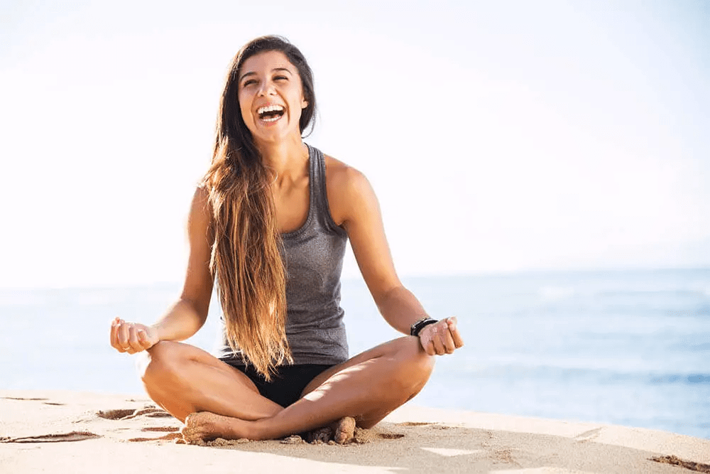 CBD and fitness routine meditating by ocean